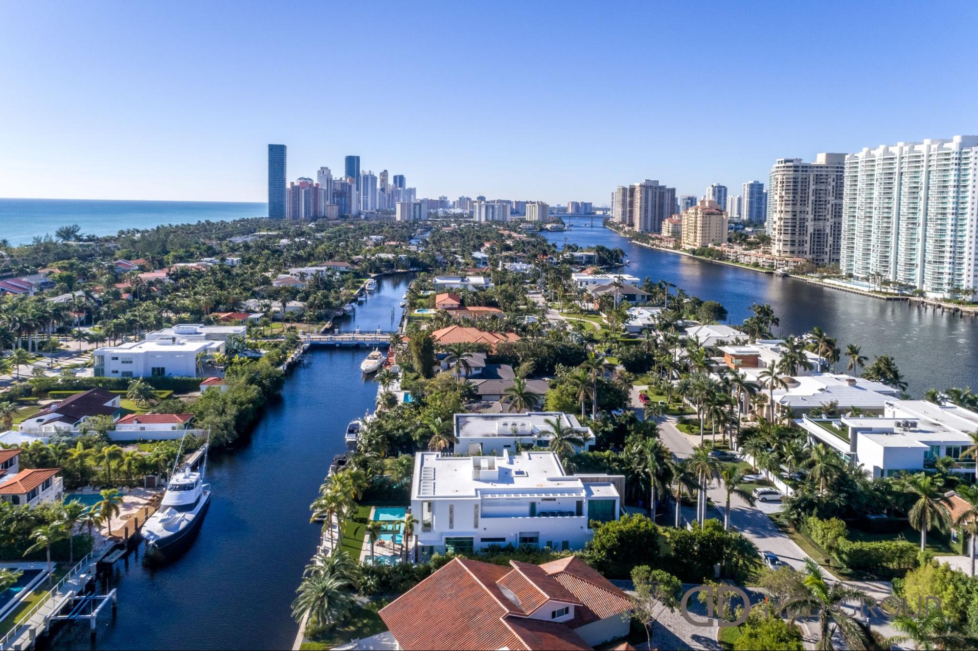 Aerial view of luxury waterfront homes and high-rise development near West Palm Beach