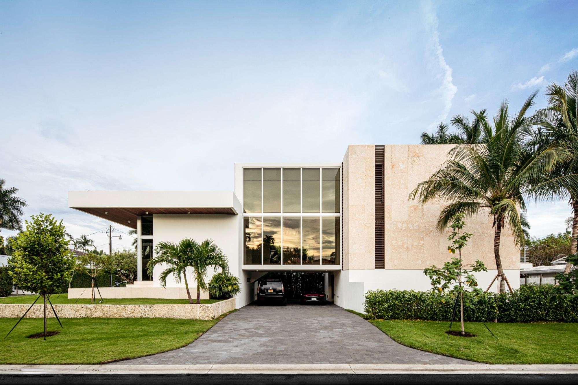 Contemporary Florida luxury home with elevated modern architecture and palm trees