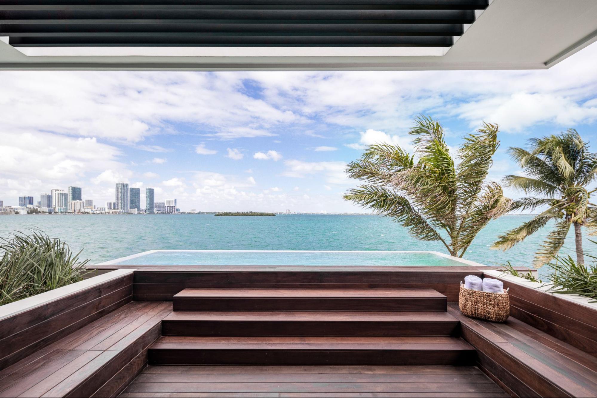 Waterfront terrace with plunge pool and panoramic water views in a Florida luxury home